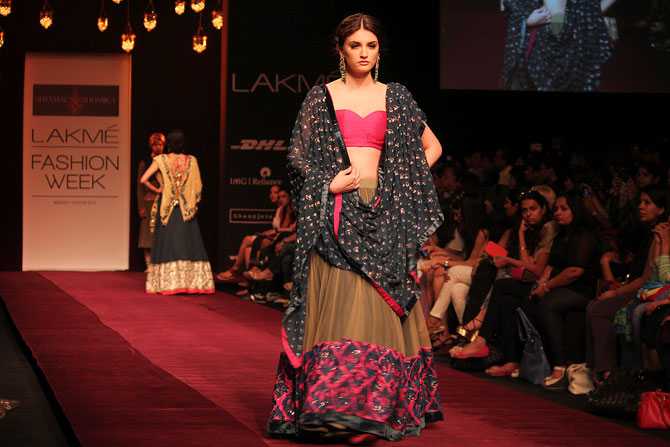 A model showcases a Shyamal and Bhumika creation.