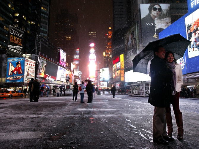 A couple have the picture taken during a snow storm in New York's Times Square.