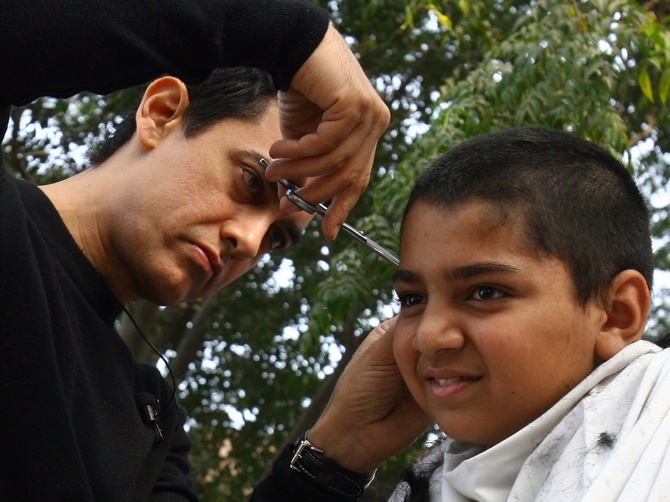 It is a myth that frequent haircuts make the hair grow faster. Seen here is Aamir Khan giving a haircut to a fan as part of a move promotion tour