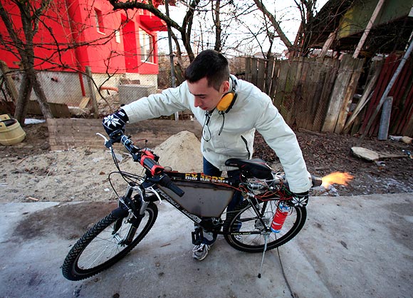 Raul Oaida tests his bicycle propelled with a self-built jet engine on a road in the back of his house in Deva, 399 km (245 miles) of Bucharest.