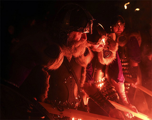 Jarl Squad vikings light up their torches during the Up Helly Aa fire festival in Lerwick, Shetland Islands, Scotland.