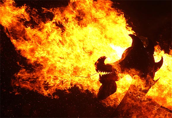 Flames engulf the dragon's head on a viking longboat as it is set on fire during the Up Helly Aa fire festival in Lerwick, Shetland Islands, Scotland.