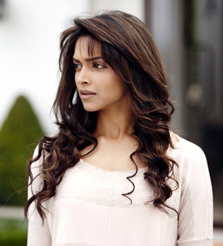 Long, side-swept bangs work well on a heart-shaped face like Deepika Padukone's
