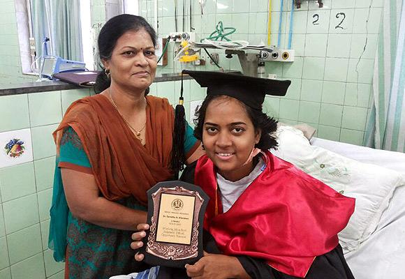 Samidha Khandare with her MBBS degree, which she received in a medical ward at  Sion Hospital, Mumbai in February this year; to the left is her mother Jayashree