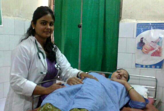 Dr Nithya Iyer inspects a pregnant lady at the government hospital