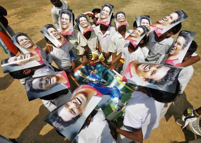 Boys from a local cricket academy wearing masks of Indian cricketer Sachin Tendulkar, celebrate his 100 international centuries in Agartala, capital of India's northeastern state of Tripura March 17, 2012. After waiting more than a year, Tendulkar finally became the first cricketer to score 100 international centuries during an Asia Cup one-day match against Bangladesh. 