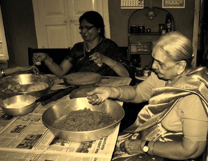 The author's grandmother (R) Sarala Kamalakar Rao Kulkarni pictured in 2011 helping make modaks.