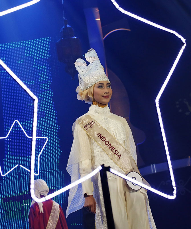 An Indonesian finalist models her designer outfit and innovative headgear.