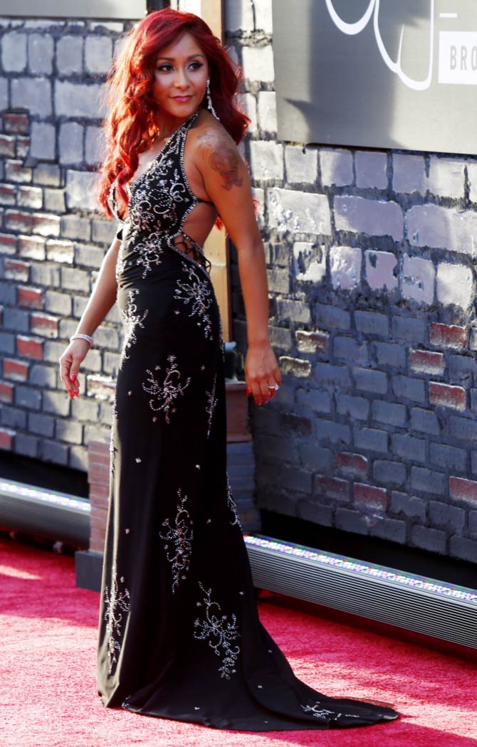 Nicole 'Snooki' Polizzi poses on arrival for the 2013 MTV Video Music Awards in New York.