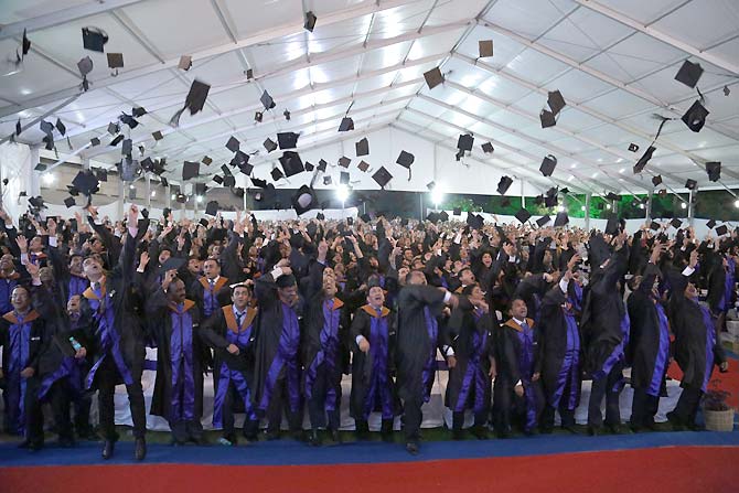 Students of ISB Hyderabad toss their hats in the air on their Graduation Day.