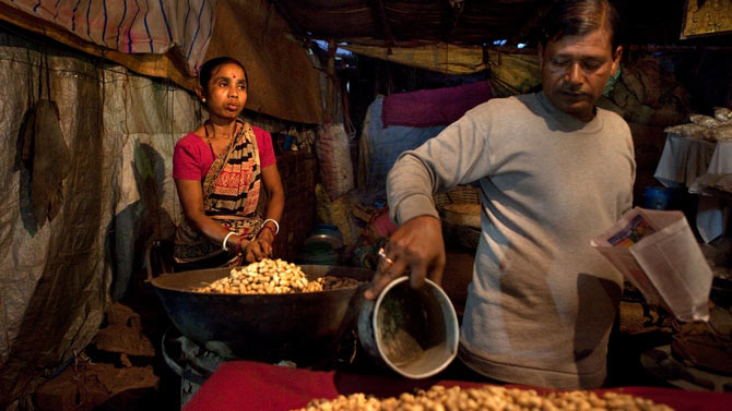 This couple earns their living selling fried groundnuts in travelling fairs. They lead an uncertain life. The family travels from one place to another and set up temporary stalls in fairs for a day or two, may be sometimes for a week. They have no time to dream but only misery of life painted on their face.
