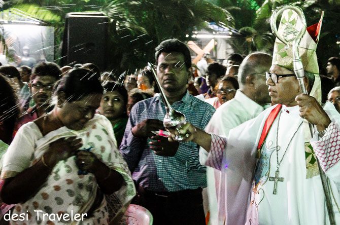 Archbishop Thumma Bala (extreme right) blesses the people who attended the mass.