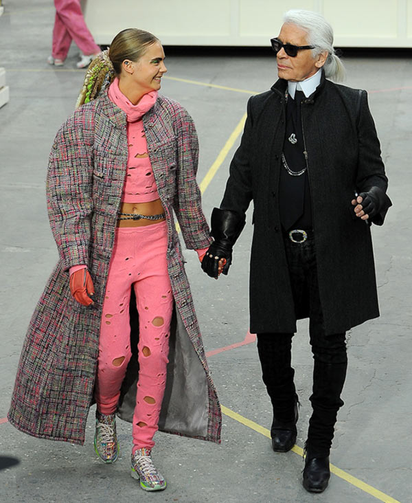 Fashion Designer Karl Lagerfeld and model Cara Delevingne appear at the end of the runway during the Chanel show as part of the Paris Fashion Week Womenswear Fall/Winter 2014-2015 on March 4, 2014 in Paris, France.