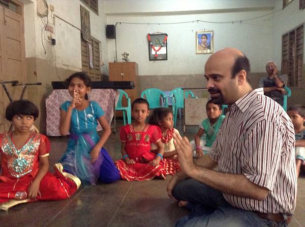 Anil Srinivasan teaching Carnatic music to underprivileged children