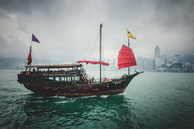 A lonely vessel passing the skyline of Hong Kong Island