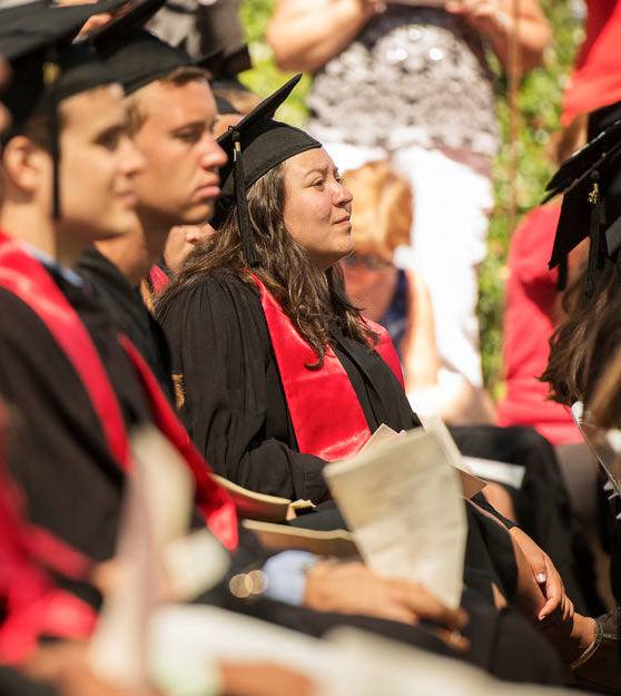 A Stanford graduate listens in as Bill Gates and Melinda Gates speak at the commencement on June 15, 2014