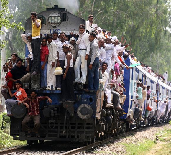 Hindu devotees travel in an overcrowded passenger train.