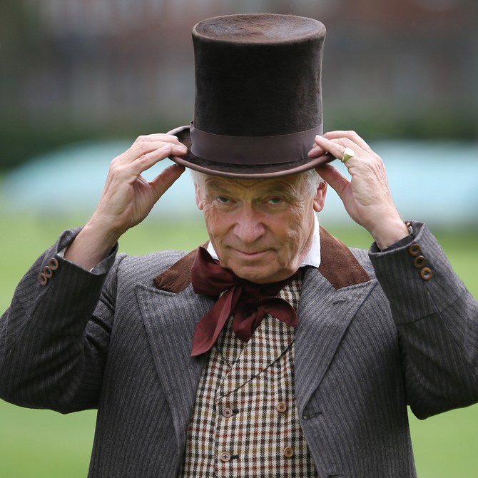 Umpire Lord Jeffrey Archer takes to the field for a Victorian cricket match at Vincent Square in London, England.