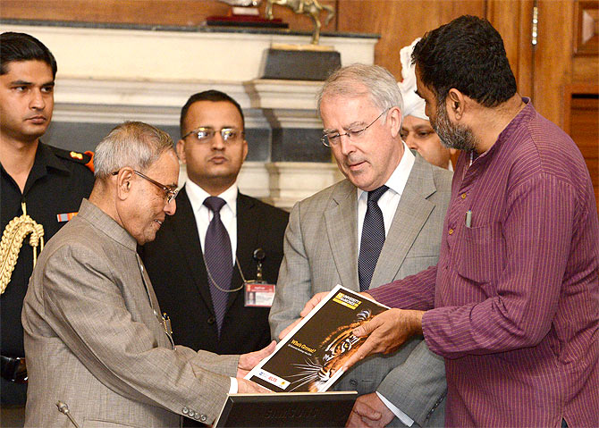 President Pranab Mukherjee receives the first copy of 'QS Asia Pacific University Rankings 2014' from TV Mohandas Pai (extreme right), Chairman, Indian Centre for Assessment & Accreditation in the presence of John O'Leary (second from right), member, executive board of QS World University Ranking at Rashtrapati Bhavan in New Delhi. 