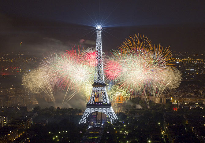 The Eiffel Tower is illuminated during the traditional Bastille Day fireworks display in Paris.