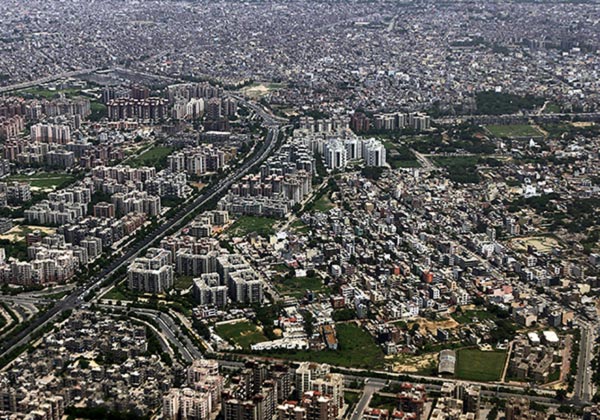 Buildings and roads are seen from the window of an airplane over New Delhi.