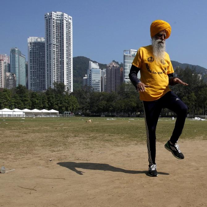 A file picture of British Indian marathon runner Fauja Singh, 101, exercising at a park in Hong Kong.