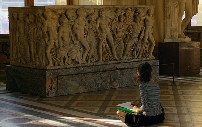 An Art student drawing at the Louvre