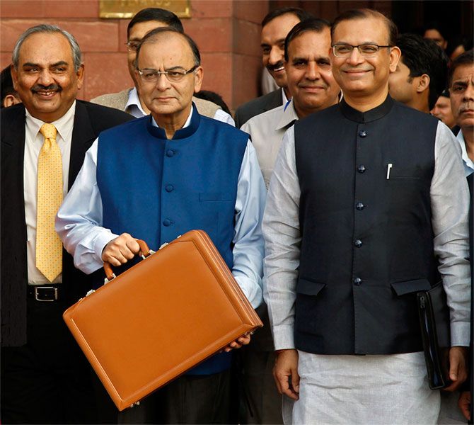 India's Finance Minister Arun Jaitley (C) poses as he leaves his office to present the 2015-16 federal budget in New Delhi February 28, 2015. 