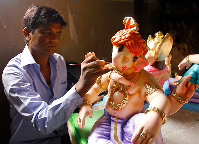 Sandeep Gajakosh lends a finishing touch to his eco-friendly Ganesh idol.