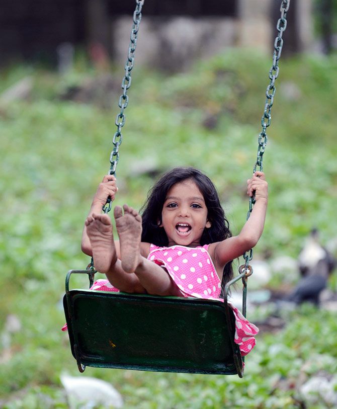 A child enjoying her ride on the swing.