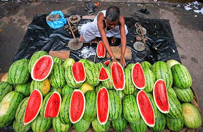 A vendor arranges watermelons for sale in Kolkata, August 4, 2011. Photograph: Rupak De Chowdhuri/Reuters
