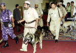 Qatari policemen with police dogs patrol the Sheraton Hotel