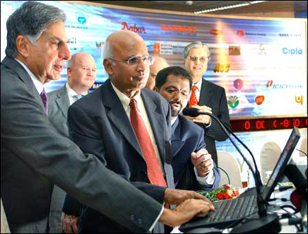Tata Group Chairman Ratan Tata (L) presses a key on a laptop to list India's largest software company, Tata Consultancy, on the Bombay Stock Exchange and the National Stock Exchange as TCS Managing Director S Ramadorai looks on in Mumbai on Wednesday. Photo: Sebastian D'Souza/AFP/Getty Images