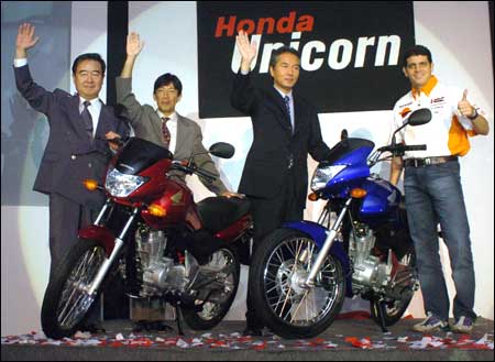 Honda Motorcycle & Scooter India (HMSI) President and CEO, Haruo Takiguchi (L), HMSI Managing Director Yukihiro Aoshima (2nd L), Director Honda Motor Japan Suguru Kanazawa (2nd R) and Moto Grand Prix rider of the Respol Honda team Alex Barros, unveil a Honda 'Unicorn' in New Delhi on Wednesday. Photo: Raveendran/AFP/Getty Images