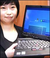 A Lenovo employee displays the new 'ThinkPad X41 Tablet'. Photograph: Yoshikazu Tsuno / AFP / Getty Images