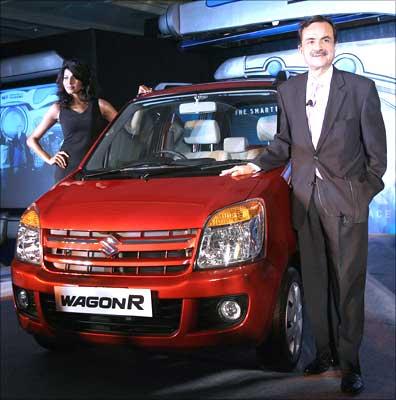 Jagdish Khattar, managing director, Maruti Udyog Limited, poses with the newly launched WagonR Duo, which can run on liquefied petroleum gas (LPG) and petrol, in New Delhi on Wednesday. Photograph: Prakash Singh / AFP / Getty Images