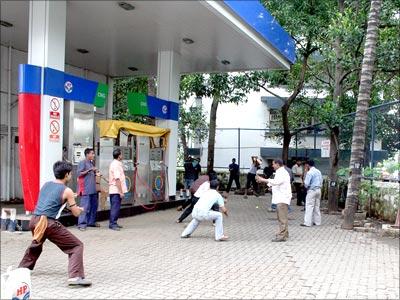 Local youth playing cricket in a petrol pump in Mumbai on Tuesday morning. The petrol dealers strike was called off on Tuesday afternoon