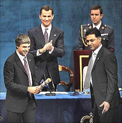 Larry Page and Google's vice-president Nikesh Arora acknowledge the applause after receiving the 2008 Prince of Asturias award for Communication and Humanities from Spain's Crown Prince Felipe