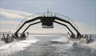 The Proteus, a cruiser known as Wave Adaptive Modular Vessel or WAM-V, blasts along on two giant inflatable tubes that let it 'dance' with waves.