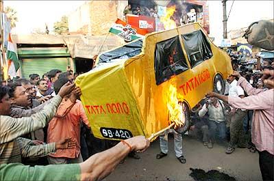 Activists of the Trinamool Congress-led 'Krishi Jami Raksha Committee' burn an effigy of the Tata Nano during a demonstration in Singur, 30 kms north of Kolkata, where the construction of the Nano car factory is in process. Photograph: STRDEL/AFP/Getty Images