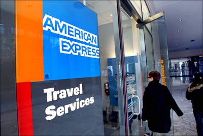 A woman walks past an American Express travel agent