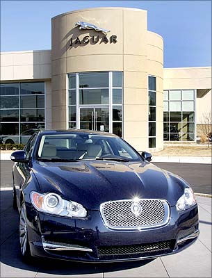 A Jaguar sits in front of a Jaguar/Land Rover dealership in Michigan