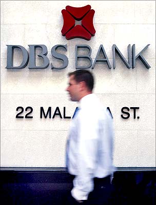 A man walks past a Development Bank of Singapore branch