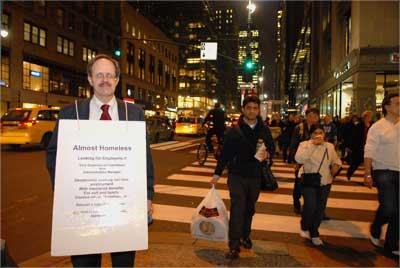 Unemployed Paul W Nawrocki of  New York hangs a poster around his neck seeking job, giving his resume to everyone, outside the Grand Central Station, 42nd Street New York on November 8