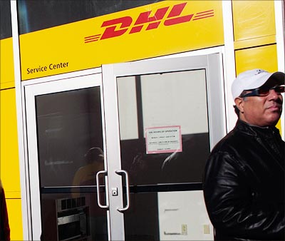 A worker steps out of a DHL distribution centre