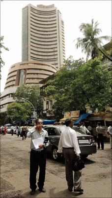 Commuters walk past the Bombay Stock Exchange in Mumbai. | Photograph: Sebastian D'Souza/AFP/Getty Images