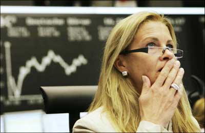 German stock trader Simone Wallmeyer looks at her screens at the stock exchange in Frankfurt/Main as the DAX index of 30 leading German shares fell by over 5%. | Photograph: Martin Oeser/AFP/Getty Images