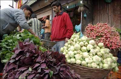 A street vendor sells vegetables. | Photograph: Rouf Bhat/AFP/Getty Images