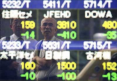 Men are reflected on an electronic display board showing share prices as they look at the board in Tokyo in Japan | Photograph: Kiyoshi Ota/Getty Images