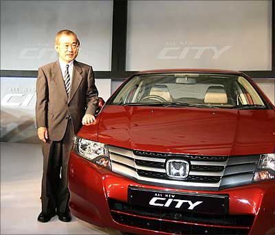 President and CEO of Honda Motors, Takeo Fukui, stands in front of the new Honda City during its launch in New Delhi on Thursday. | Photograph: Raveendran/AFP/Getty Images
